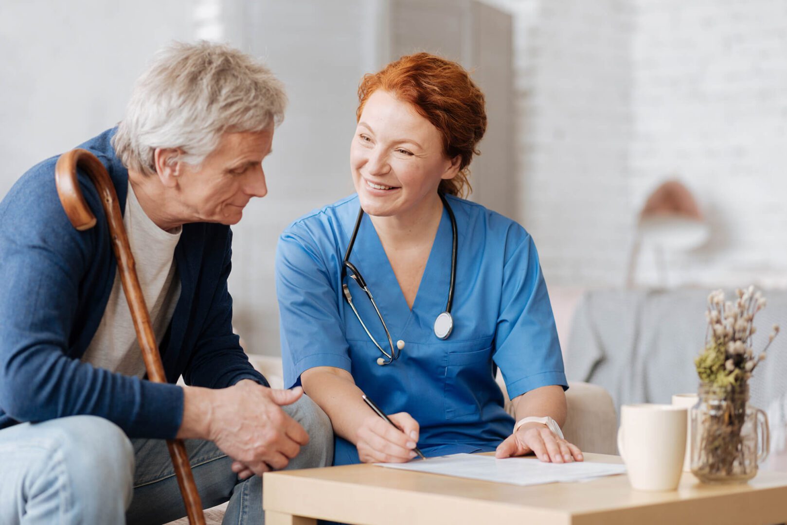 A nurse and an old man shaking hands